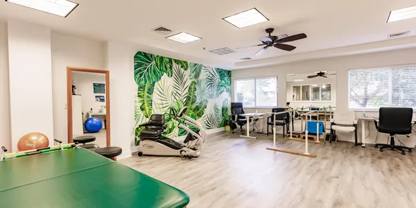 A room with a green wall and some chairs